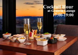 a table with glasses of champagne and bowls of food at Hotel Granvia Kyoto in Kyoto