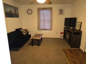 a living room with a couch and a coffee table at The Happy Place in Glouster