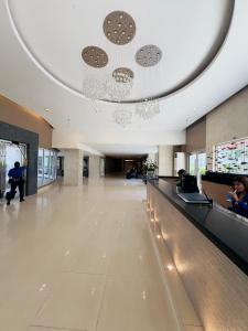 a lobby of a building with a long hallway at Sea Residences Mall of Asia Viann in Manila +42 photos