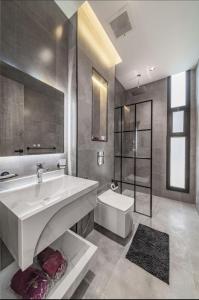 a large bathroom with a sink and a toilet at SADEN Al-Salama in Jeddah +54 photos