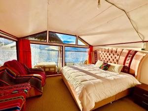 a bedroom in a boat with a bed and a chair at Uros Qota Uta in Puno
