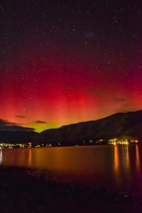 a starry night over a body of water at Self-Contained Wanaka GuestHouse in Wanaka