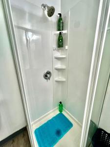 a shower with a blue mat in a bathroom at Furnished Private Room with Shared Bathroom near SeaTac Airport in Seattle