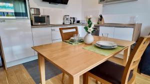 a kitchen with a wooden table with two plates on it at Modern Apartment, central in Bad Aibling in Bad Aibling