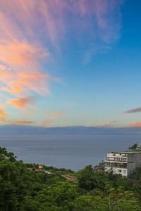 a view of the ocean under a cloudy sky at Samastiti Bingin in Uluwatu