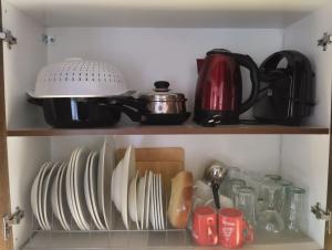 a cupboard with plates and utensils on it at Elatodasos in Taxiarchis