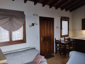 a room with a bed and a table and a window at Elatodasos in Taxiarchis