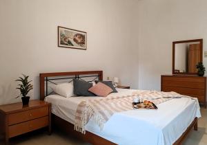 a bedroom with a bed with a tray of food on it at Konstantina's cottage Ideal BaseforBalos & Elafonisi in Kissamos +46 photos