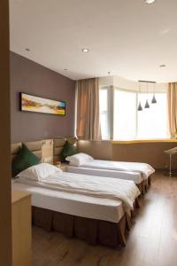 a room with three beds in a room at Shanghai Blue Mountain Bund Youth Hostel in Shanghai