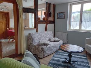 a living room with a couch and a table at Le Balcon in Sélestat +17 photos