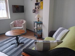 a living room with two chairs and a table at Le Balcon in Sélestat
