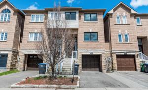 een groot bakstenen huis met twee garages bij Beautiful Studio with Patio in Mississauga in Mississauga