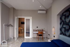 a bedroom with a bed and a dining room at La Suite del Barone in Lecce