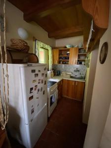 a kitchen with a white refrigerator and a stove at Chata Pastviny in Pastviny +7 photos