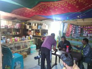 a group of people standing around a table in a store at Hotel Chandrlok in Madheso