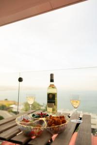 a table with a bowl of food and a bottle of wine at פרמיום בכינרת in Tiberias