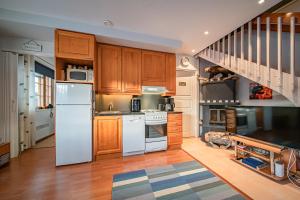 a kitchen with white appliances and wooden cabinets at Levinalppi 2 App 8 in Kittilä