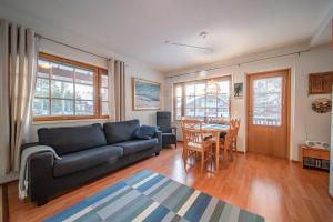 a living room with a couch and a table at Levinalppi 2 App 8 in Kittilä