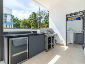 a kitchen with a sink and a stove at Miram #4 - Three Bedroom Villa Across The Beach in Coco