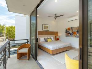 a bedroom with a bed and a balcony at Miram #4 - Three Bedroom Villa Across The Beach in Coco +37 photos