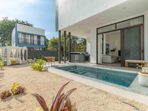 a house with a swimming pool in the backyard at Miram #4 - Three Bedroom Villa Across The Beach in Coco