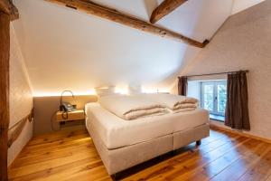 a bedroom with a bed and a window at Le Vieux Moulin Weywertz in Butgenbach