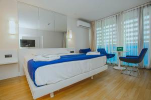 a bedroom with a bed and a table and chairs at Panorama Central Batumi in Batumi +67 photos