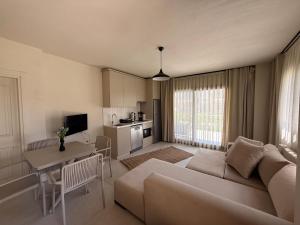 a living room with a couch and a table at Mara Bahçe Alaçatı in Çeşme