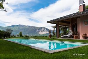 a swimming pool in the grass next to a house at B&B Renalù in Verbania