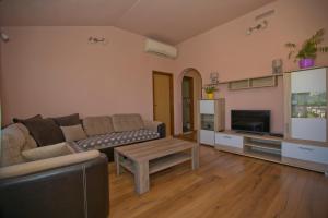a living room with a couch and a table at Apartmani Vini in Hvar