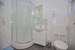 a bathroom with a shower and a toilet and a sink at Apartmani Vini in Hvar +40 photos