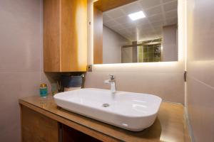 a bathroom with a white sink and a mirror at Antalya NO:6 Luxury Comfort Art House in Antalya +16 photos