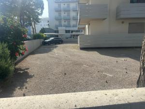 a car parked in a parking lot next to a building at Residence Patty in Caorle