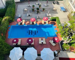 an overhead view of a swimming pool with tables and umbrellas at Hotel Principe in Sanremo