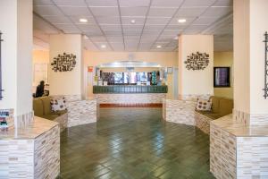 a lobby of a store with tables and chairs at Castle Harbour with heated pool ap Patricia in Los Cristianos +40 photos