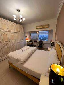 a bedroom with a large bed and a living room at Zamalek Nile view beside Marriott in Cairo +22 photos