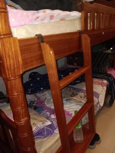 a wooden bunk bed with a ladder on it at New Masala Indian restaurant in Bangkok