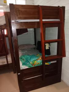 a wooden bunk bed with a glass door at New Masala Indian restaurant in Bangkok