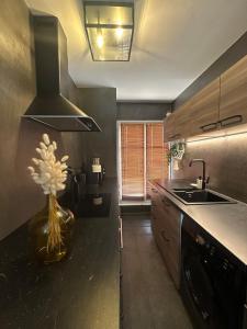 a kitchen with a vase of flowers on the counter at Outstanding Apartment-Near Disneyland Paris in Chessy