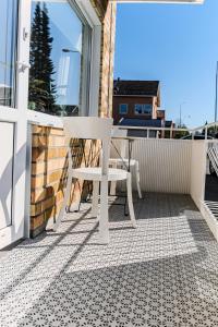 a white table and chair on a balcony at Nice 4 room apartment at Älvsbacka in Skellefteå