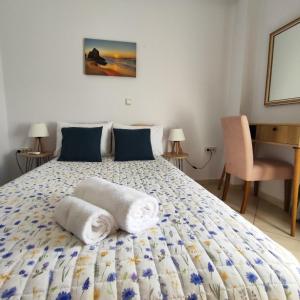 a bedroom with a bed with towels on it at GDE SPETSES 3bdr HOUSE in Spetses