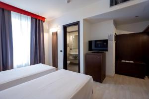 Postel nebo postele na pokoji v ubytování Stadio Hotel