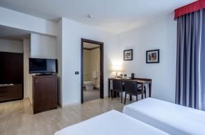 Postel nebo postele na pokoji v ubytování Stadio Hotel