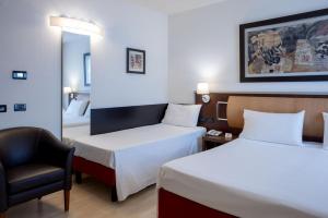 Postel nebo postele na pokoji v ubytování Stadio Hotel