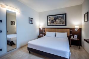 Postel nebo postele na pokoji v ubytování Stadio Hotel