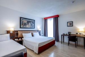 Postel nebo postele na pokoji v ubytování Stadio Hotel