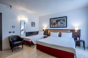 Postel nebo postele na pokoji v ubytování Stadio Hotel