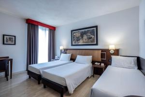 Postel nebo postele na pokoji v ubytování Stadio Hotel