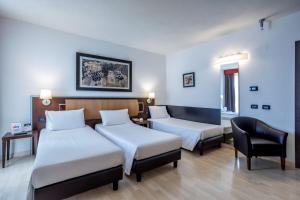 Postel nebo postele na pokoji v ubytování Stadio Hotel