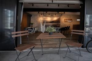 a table and two chairs in a room at Modern Container House - 2 Min Walk to Matsubara Beach - Sleeps 7 in Tsuruga